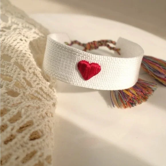 White Woven Embroidered Tassel Bracelet with Red Heart Accent - Picture 1 of 8